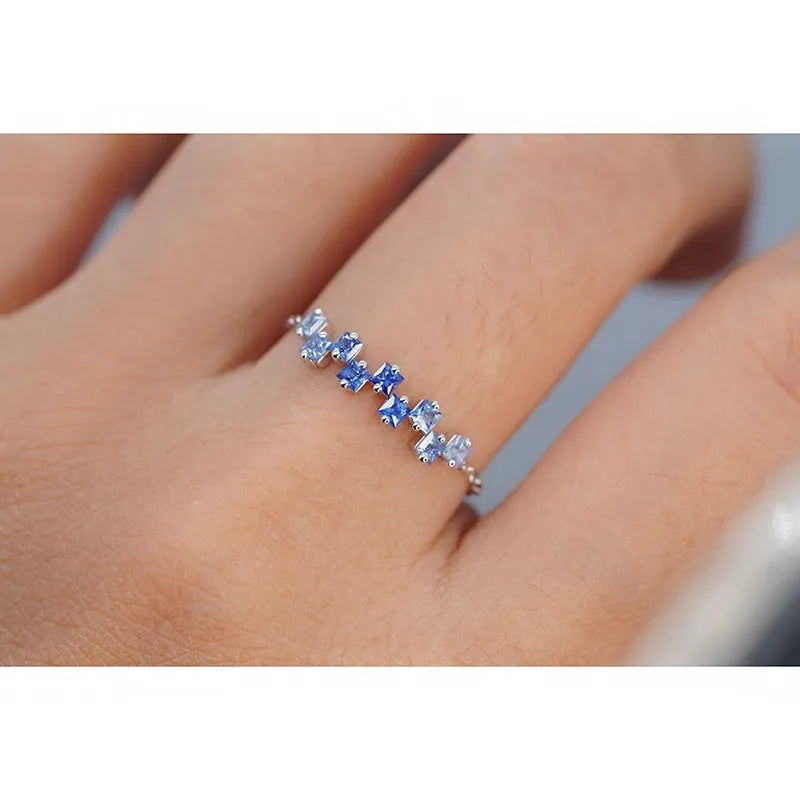 Square blue stone ring with adjustable copper band and floral leaf detailing in blue