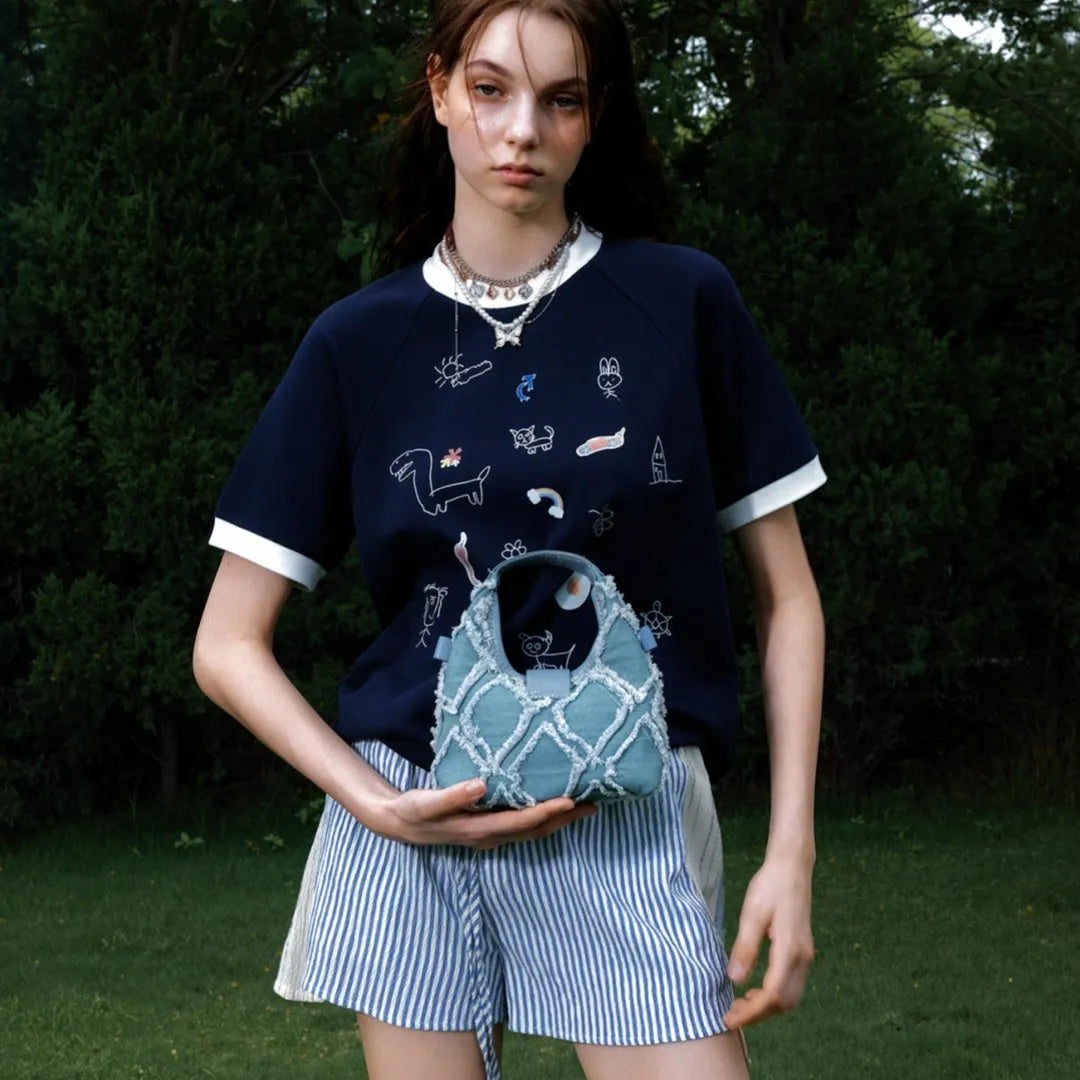Men's blue loose fit short sleeve shirt with a cartoon print design on the front.